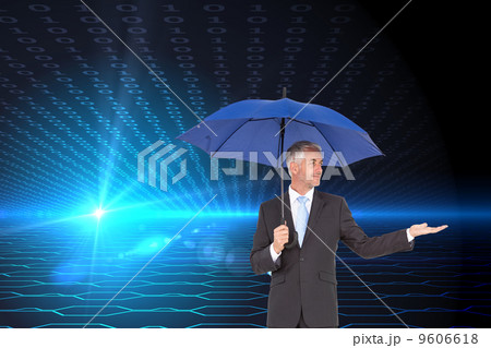 Composite image of happy businessman holding umbrella 9606618
