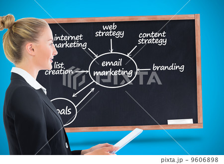 Composite image of businesswoman holding tablet 9606898