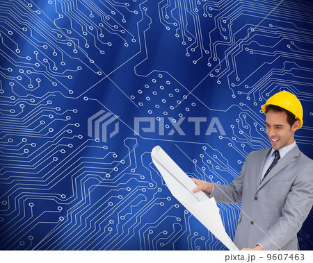 Composite image of smiling architect with hard hat looking at pl 9607463