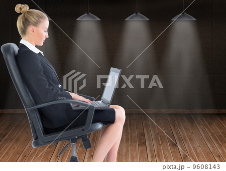Composite image of businesswoman sitting on swivel chair with la Composite image of businesswoman sitting on swivel chair with la 9608143