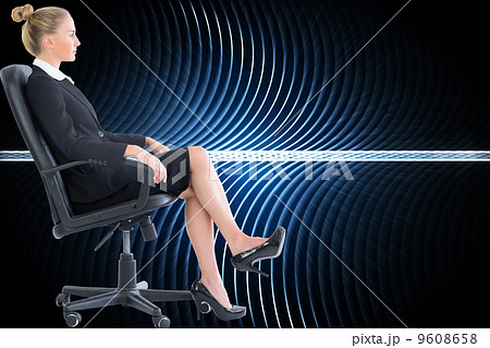 Composite image of businesswoman sitting on swivel chair in blac 9608658
