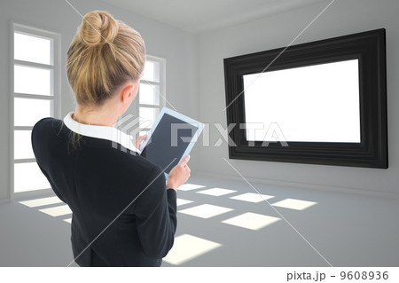 Composite image of businesswoman holding new tablet Composite image of businesswoman holding new tablet 9608936