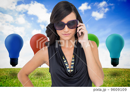 Composite image of serious elegant brunette wearing sunglasses o 9609109