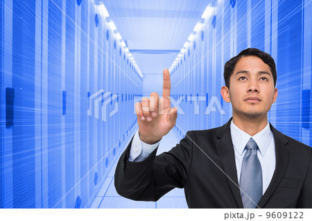Composite image of stern asian businessman pointing Composite image of stern asian businessman pointing 9609122