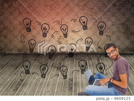 Composite image of man wearing glasses sitting on floor using la Composite image of man wearing glasses sitting on floor using la 9609125
