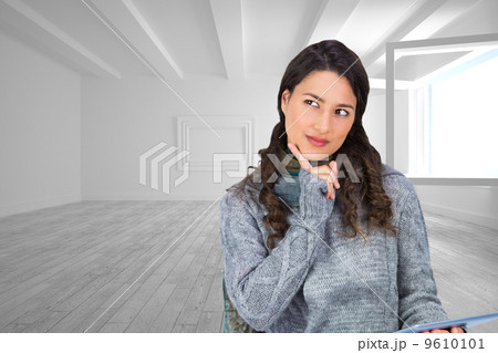Composite image of pensive model wearing winter clothes holding Composite image of pensive model wearing winter clothes holding 9610101