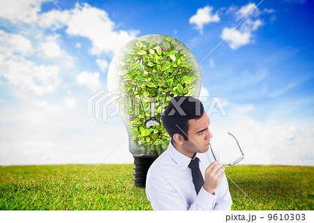 Composite image of unsmiling businessman holding glasses Composite image of unsmiling businessman holding glasses 9610303