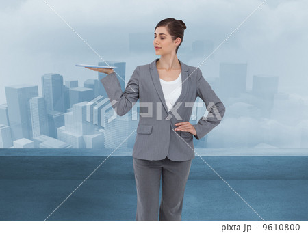 Composite image of businesswoman holding tablet computer Composite image of businesswoman holding tablet computer 9610800