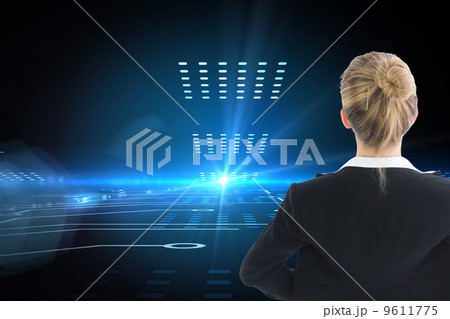 Composite image of businesswoman standing with hands on hips 9611775