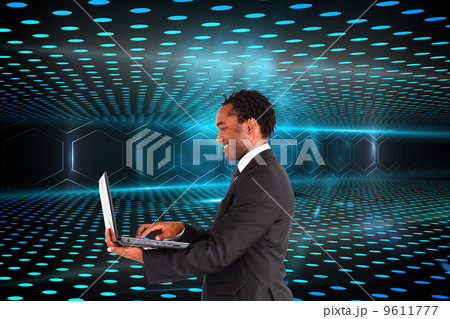 Composite image of businessman working on laptop 9611777