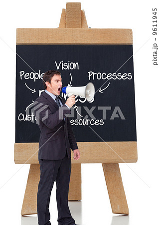 Composite image of standing businessman shouting through a megap Composite image of standing businessman shouting through a megap 9611945