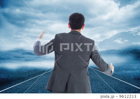 Composite image of businessman catching 9612213