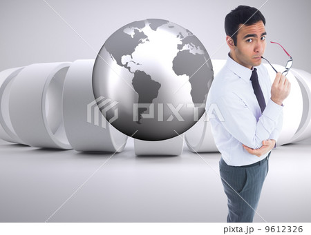 Composite image of unsmiling businessman holding glasses 9612326