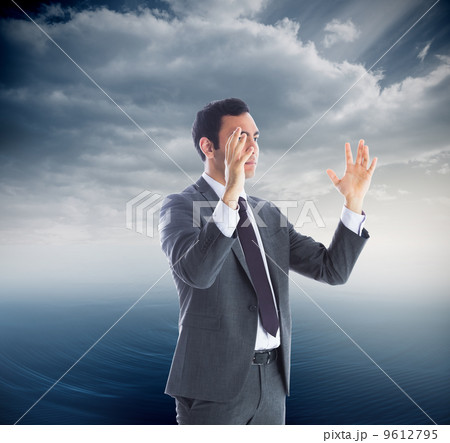 Composite image of unsmiling businessman with arms raised 9612795