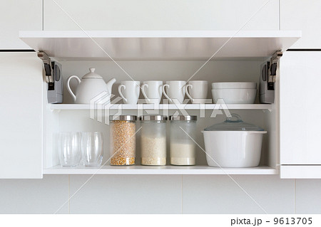 opened cupboard with kitchenware inside opened cupboard with kitchenware inside 9613705
