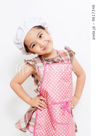 Happy little Asian cute chef wearing pink apron 9617346