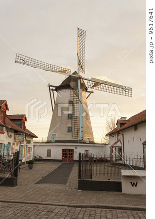 Vintage stone windmill in flanders belgium 9617641