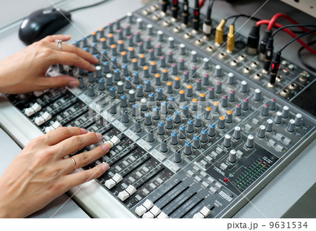 female hands at audio control console 9631534