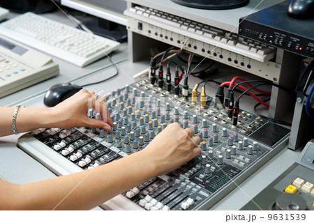 female hands at audio control console 9631539