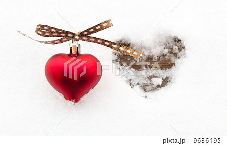Red heart on snow next to melted heart shape Red heart on snow next to melted heart shape 9636495