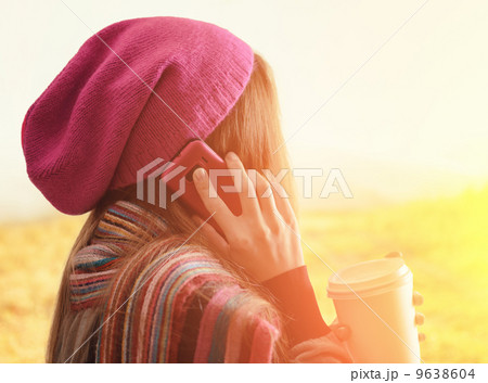 Young woman holding a tumbler of coffee. Outdoor portrait Young woman holding a tumbler of coffee. Outdoor portrait 9638604