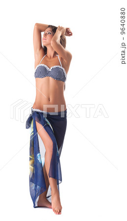 Young girl posing in polka dot bikini with pareo 9640880