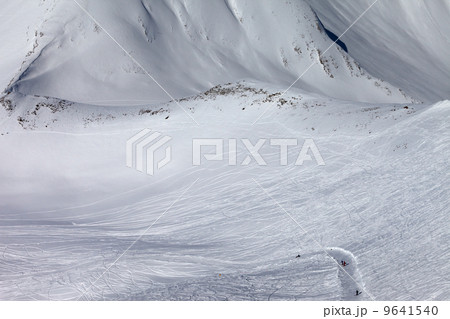 Snowboarders and skiers on slope and off-piste slope with trace Snowboarders and skiers on slope and off-piste slope with trace 9641540