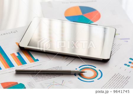 Financial charts on the table with tablet and pen Financial charts on the table with tablet and pen 9641745