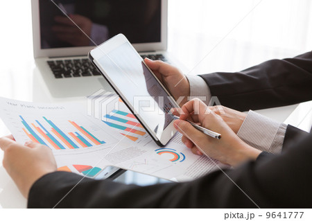 Close-up of business team using digital tablet with financial d Close-up of business team using digital tablet with financial d 9641777