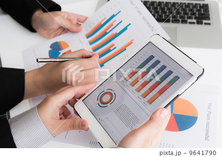 Close-up of  business team using digital tablet with financial d 9641790