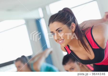 People doing power fitness exercise at yoga class People doing power fitness exercise at yoga class 9644346
