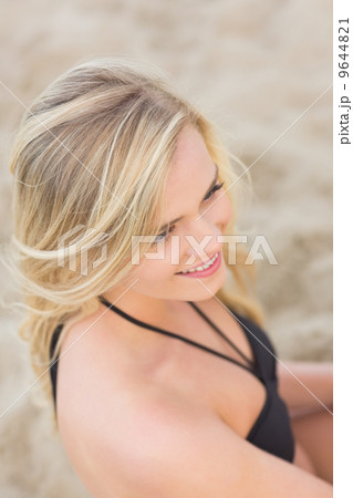Overhead Close up of a smiling relaxed blond at beach 9644821