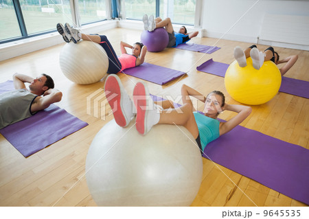 High angle view of class exercising with fitness balls High angle view of class exercising with fitness balls 9645535