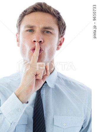 Businessman with finger on lips 9650733