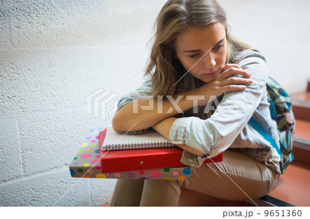 Sad student sitting on stairs 9651360
