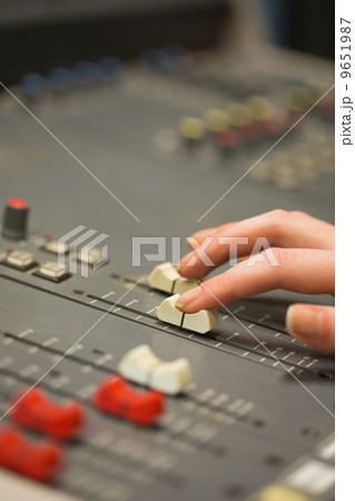 Student working on sound desk adjusting levels 9651987