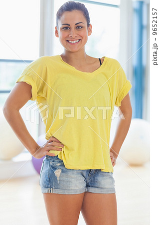 Portrait of a smiling fit young woman in yellow top Portrait of a smiling fit young woman in yellow top 9652157