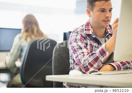 Happy student working in the computer room 9652210