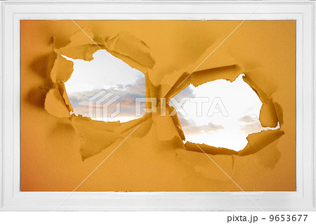Rip on wall showing bright sky 9653677