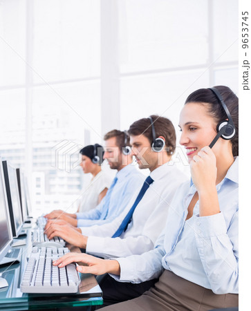 Business colleagues with headsets using computers 9653745