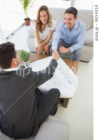 Smiling couple in meeting with a financial adviser Smiling couple in meeting with a financial adviser 9654016