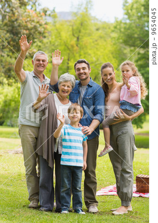 Extended family waving hands in park Extended family waving hands in park 9654045
