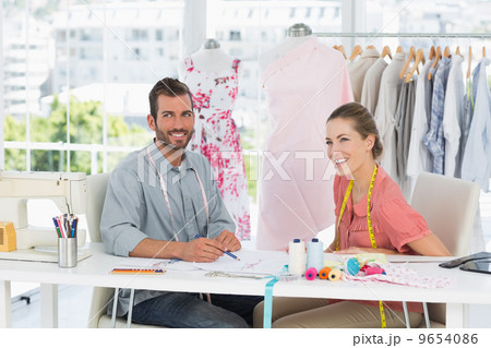 Fashion designers at work in bright studio 9654086