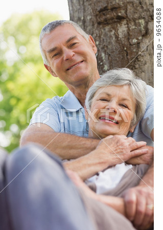 Senior man embracing woman from behind at park Senior man embracing woman from behind at park 9654088