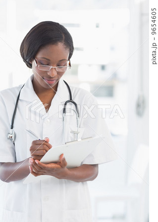 Female doctor writing report 9654605