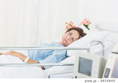 Female patient sleeping in medical bed 9654844