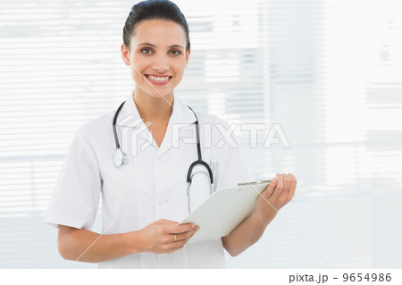 Portrait of a beautiful young female doctor with clipboard Portrait of a beautiful young female doctor with clipboard 9654986