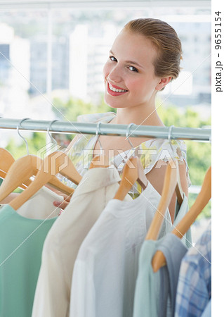 Happy female customer selecting clothes in store Happy female customer selecting clothes in store 9655154