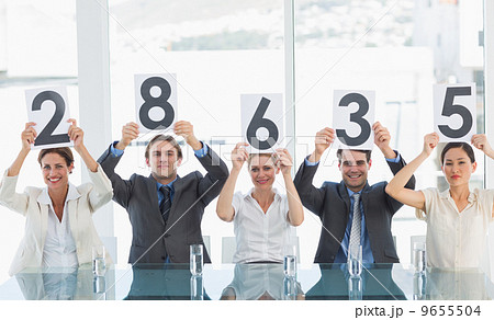 Group of panel judges holding score signs 9655504