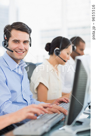 Business colleagues with headsets using computers Business colleagues with headsets using computers 9655516